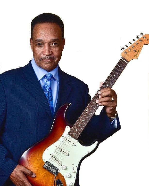 Johnny Rawls portrait with electric guitar in navy suit